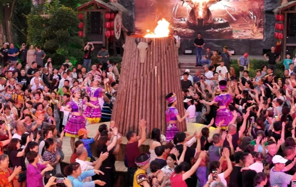 In Zhangjiajie, people from ethnic minorities dance hand waving dance around the bonfire